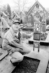 Radu, our guide, explaining a tombstone at the Merry Cemetery in Sapanta, Romania. 