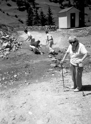 Everybody is throwing rocks in the river to make a path for Flory to cross.