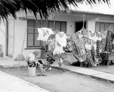 A Kuna woman in San Blas creates a new mola while displaying her wares.