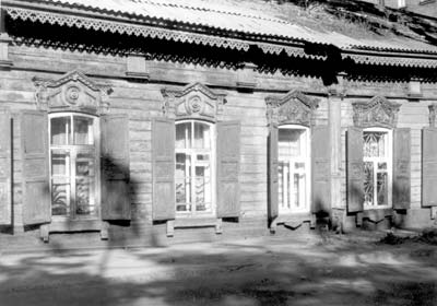 Old house in Irkutsk with wooden lace trim and fancy windows.