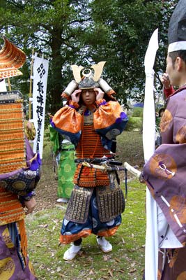 Young warrior adjusts his headdress before the opening parade.