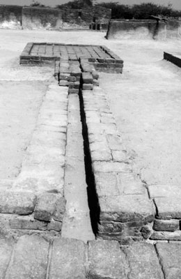 Foundations of a former brick-paved bath and drain in the upper town at Lothal, India.