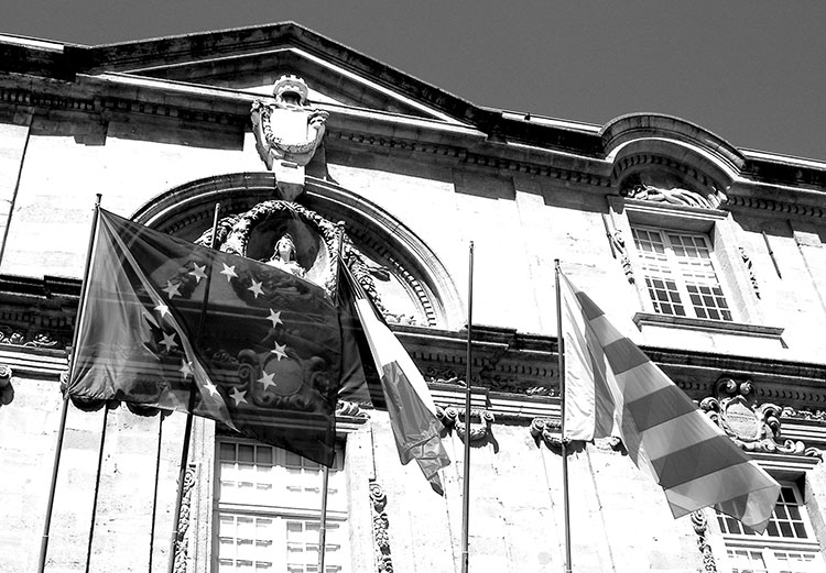 On European town halls, locals often fly three flags. Here, in Aix-en-Provence, you’ll see (right to left) the regional (Provence), national (France) and European flags. Photo: Steves