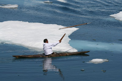 Inuit demonstrating how to throw a spear with an atlatl.