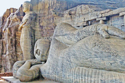 The standing image, either the Buddha or a disciple, and the colossal reclining Buddha — Gal Vihara, Polonnaruwa. Photo: Patten