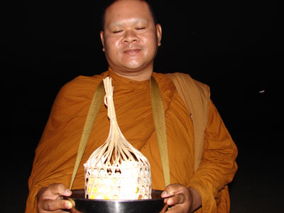 Monk giving his blessing after receiving the package of food our hotel prepared as an offering.