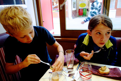 Travelers of all ages — here trying snails for the first time — can reach new gastronomic heights in France. Photo by Rick Steves