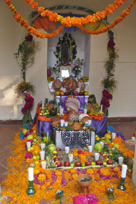 Candles ornament a Day of the Dead altar dedicated to a loved one in Cuernavaca. Photo by Catie Bursch