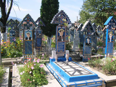 Grave of the original artist who carved and painted many of the markers in the Merry Cemetery — Sapânta, Romania. Photo by Bob Derge