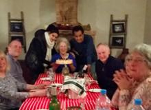 Edna R.S. Alvarez (center), flanked by the chef de cuisine and the guest house owner, receiving a cake for her 78th birthday —  Sel d’Ailleurs.