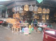 This man was selling birds (probably canaries), cages, food and other items at a