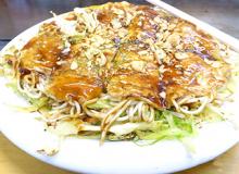 A plate of okonomiyaki.