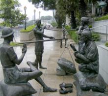 “A Great Emporium,” by Malcolm Koh, is one of four sculptures in the historically themed “People of the River” series along the Singapore River in Singapore.