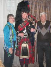 Anne and Jack Dini with a piper in Edinburgh. 