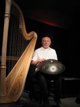 Harpist Luc Vanlaere, with a hang in his lap, in Bruges, Belgium. 