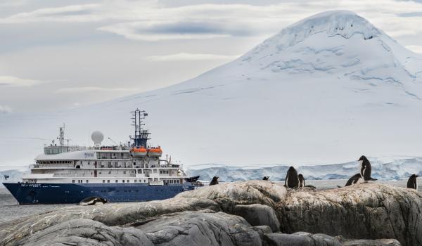 The Sea Spirit glides by a glacier.