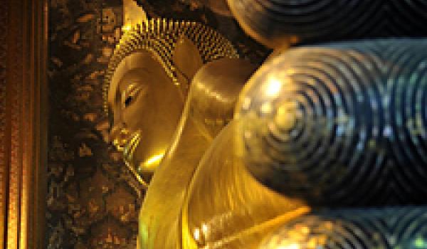 Toes of the 46-meter-long reclining Buddha at Wat Pho temple in Bangkok, Thailand. The figure was built with bricks, shaped with plaster, then gilded.