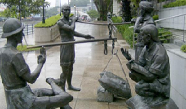 “A Great Emporium,” by Malcolm Koh, is one of four sculptures in the historically themed “People of the River” series along the Singapore River in Singapore.