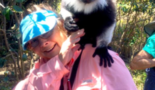 Libby Cagle with a lemur on her shoulder, at Varuna Resort in Madagascar. Photo by Roger McDaniels