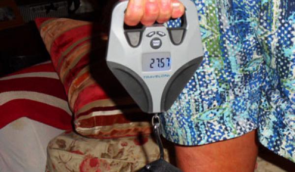 Don’s wife, Mary, demonstrates their Travelon luggage scale.