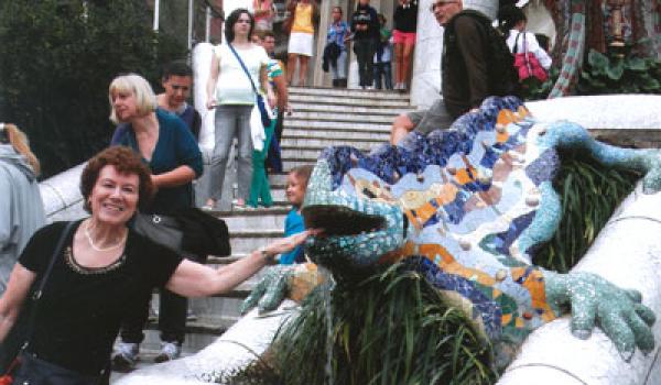 Arlene Lichtenstein tempting the Gaudí lizard in Parc Güell — Barcelona.