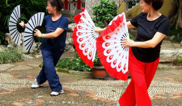 Two women performed morning exercises in the courtyard of Lou Lim Iok Garden.