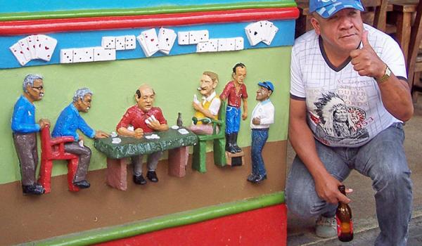 A Guatapé local poses by a pub-front “socket” for which he served as a model.