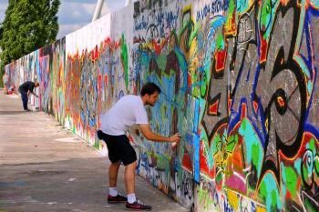 The wall that once separated East and West Berlin is now a place where people come with spray cans to create wild and crazy art.