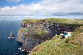 For cheaper entry and a more peaceful experience, visit the Cliffs of Moher early or late in the day. Photo by Arizona Bonuccelli