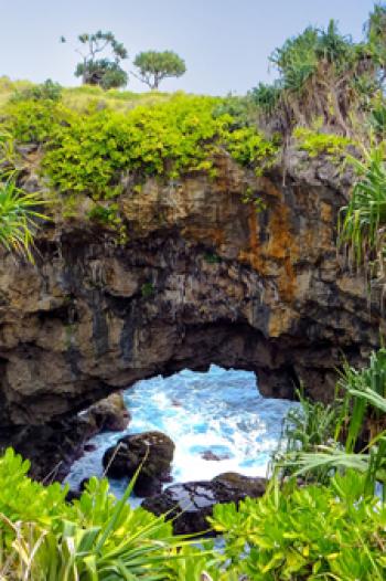 On Tonatapu island in Tonga, the Hufangalupe Archway, a land bridge over the crashing waves of the Pacific, formed when the roof of a sea cave collapsed. Photo ©donyanedomam/123rf.com