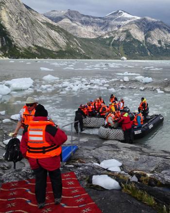 Wanda Bahde photographing fellow passengers arriving at Pia Glacier in Chile. Photo by Ray Bahde