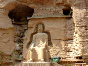 A large buddha overlooks the river at Binglingsi Shiku.