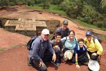 Bob, Addis, Matt, Anna, Javi and Joan kneeling above the Church of St. George in Lalibela, Ethiopia. Photo by Tefera Alemu