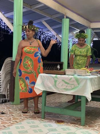 Our colorful progressive-dinner hostess and her daughter preparing for the group to hit the dessert table.