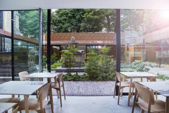 The Garden Museum's café and the courtyard with the tomb of John Tradescant the elder and John Tradescant the younger. Photo by Andrew Burton, The Garden Museum 