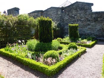 Dunbar’s Close Garden shares an old stone wall with the church next door.