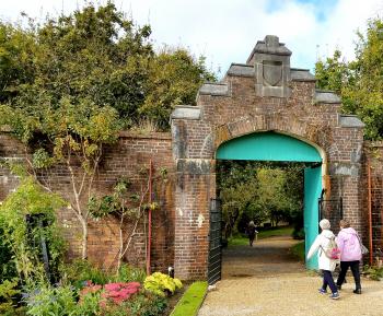 Garden gate leading to a woodland path.