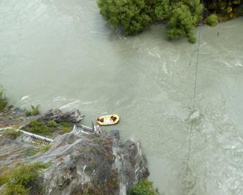 Two men in a raft below the bridge helped bungee jumpers climb into the boat from the water. 