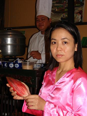 Ms. Nhu, our cooking class interpreter, displaying a banana flower. Photos by Sandra Scott