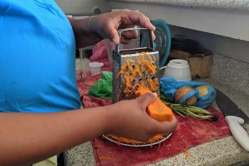 Sara shredding carrots.