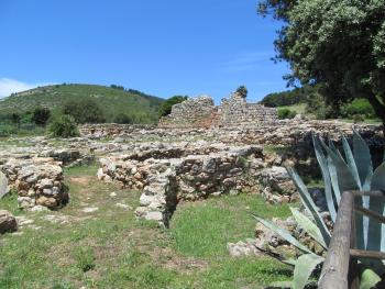 Nuraghe Palmavera, with stone hut bases in the foreground.