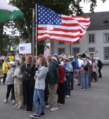 Americans line up behind the US flag to march in the opening ceremony of the 15th IVV Olympiad — Koblenz.