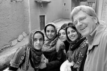 Rick Steves poses with teenage girls in Iran, a place that might give many Americans culture shock.