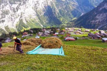 A farmer loads up his tarp for a hayride directly to the barn. Photo by Rick Steves